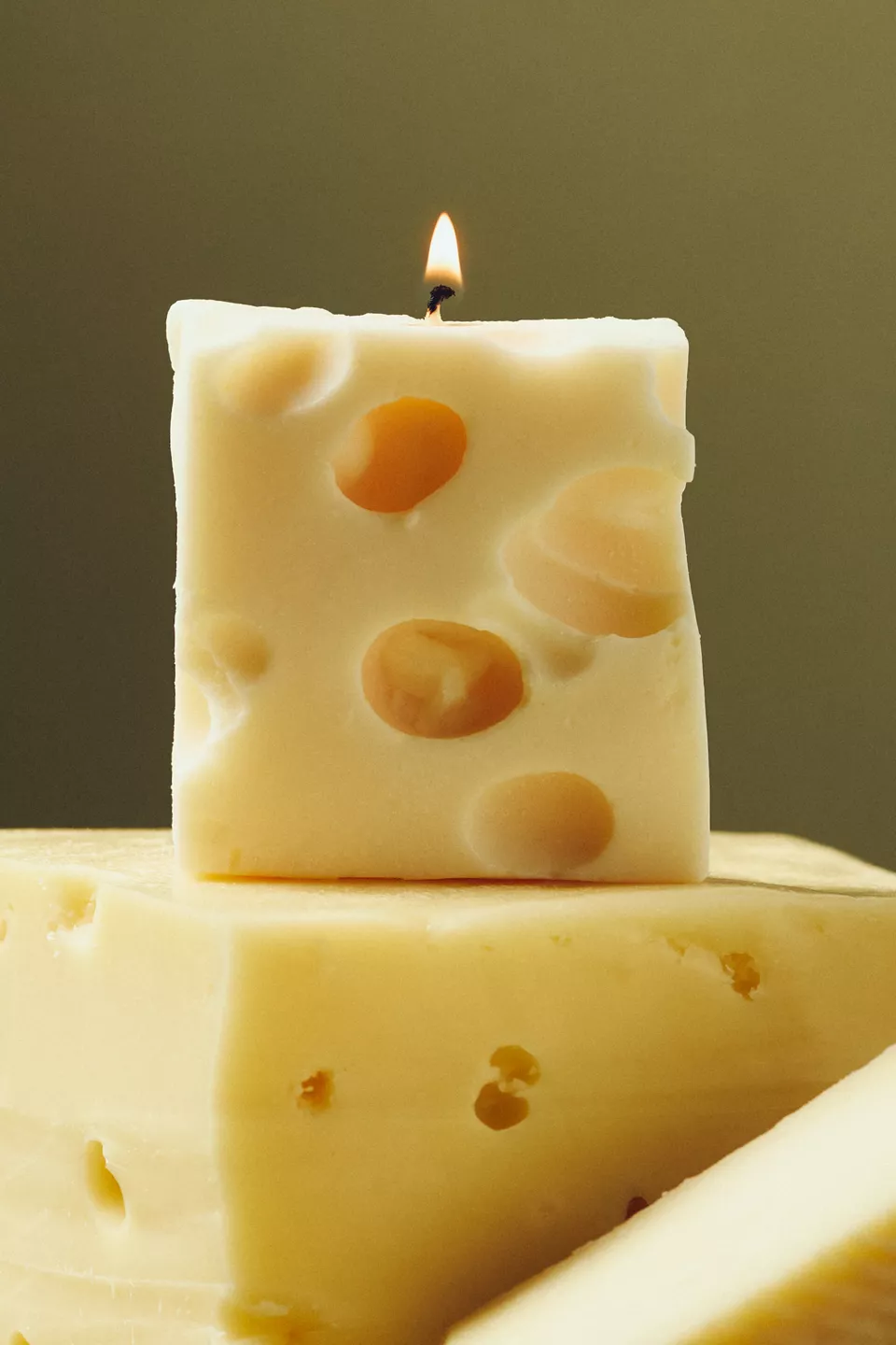 A yellow cheese shaped candle