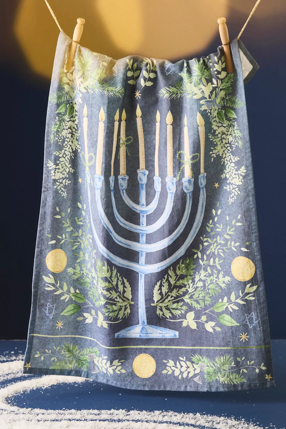 A blue dish towel with a menorah on it