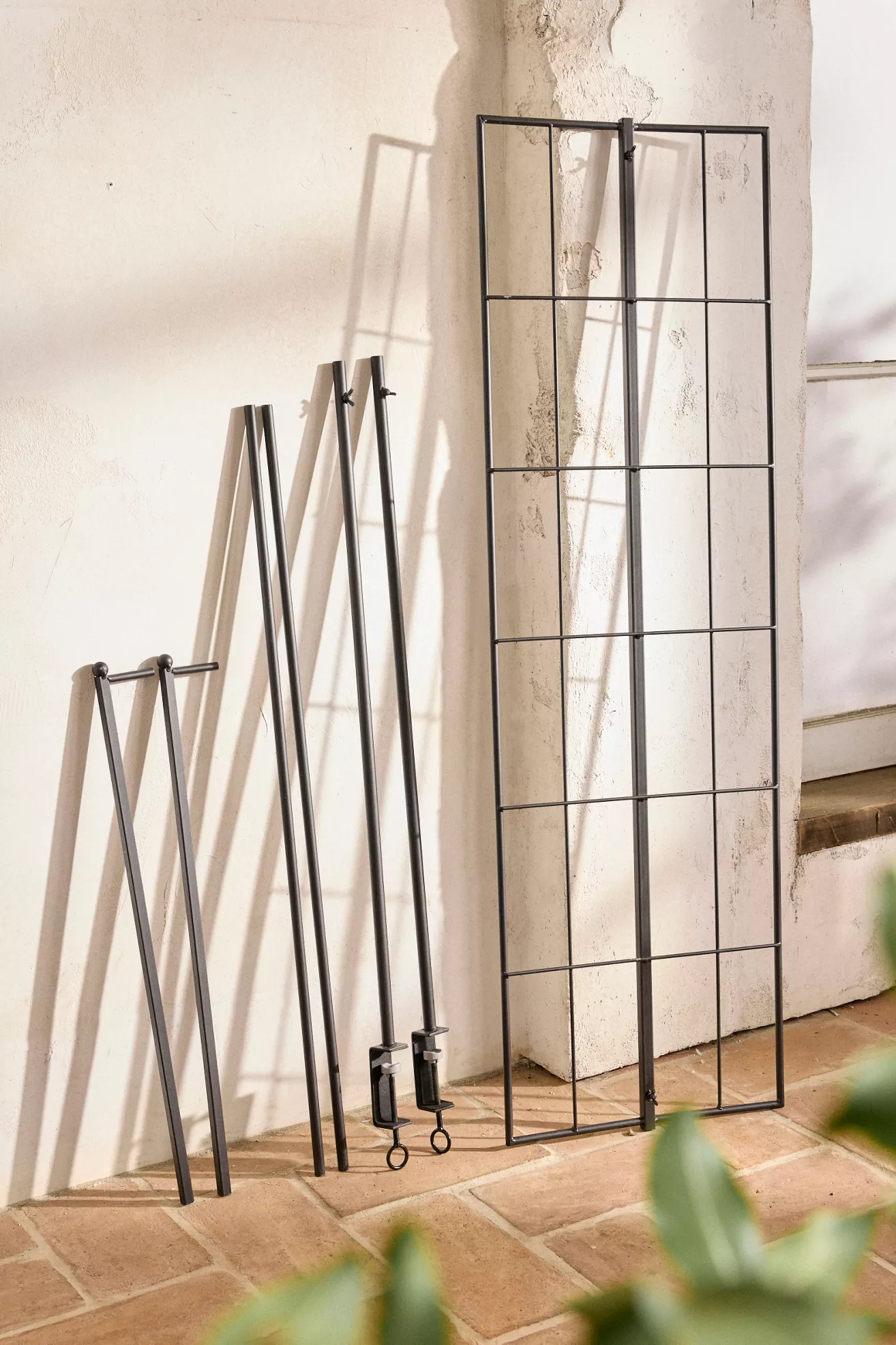 Metal grid trellis panels leaned against a wall