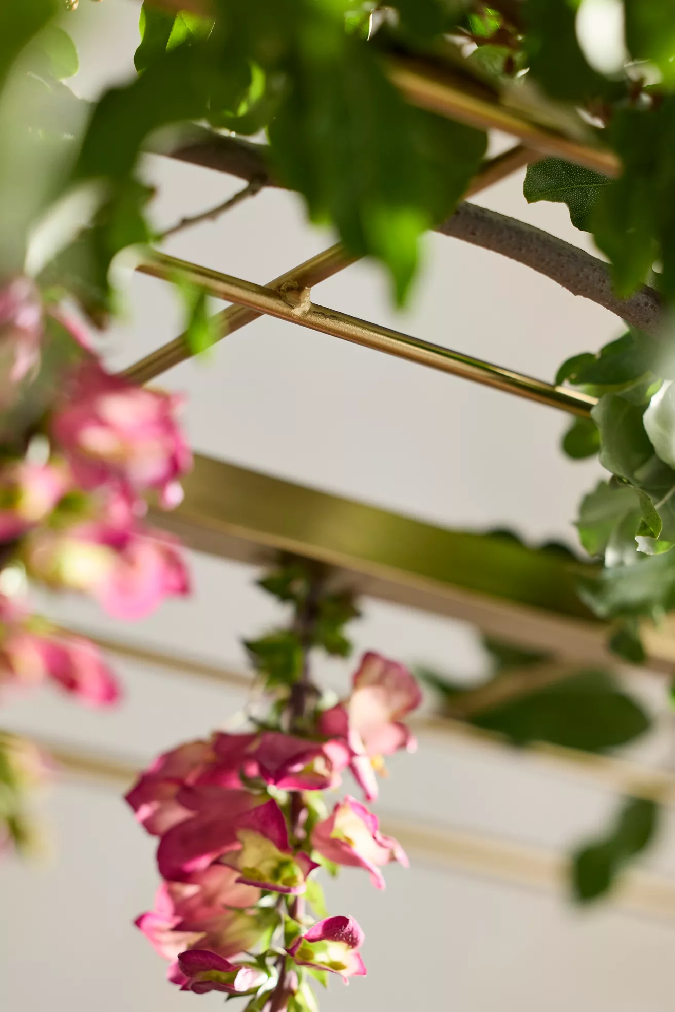 Close-up of tied greenery on gold trellis showing joints and finish