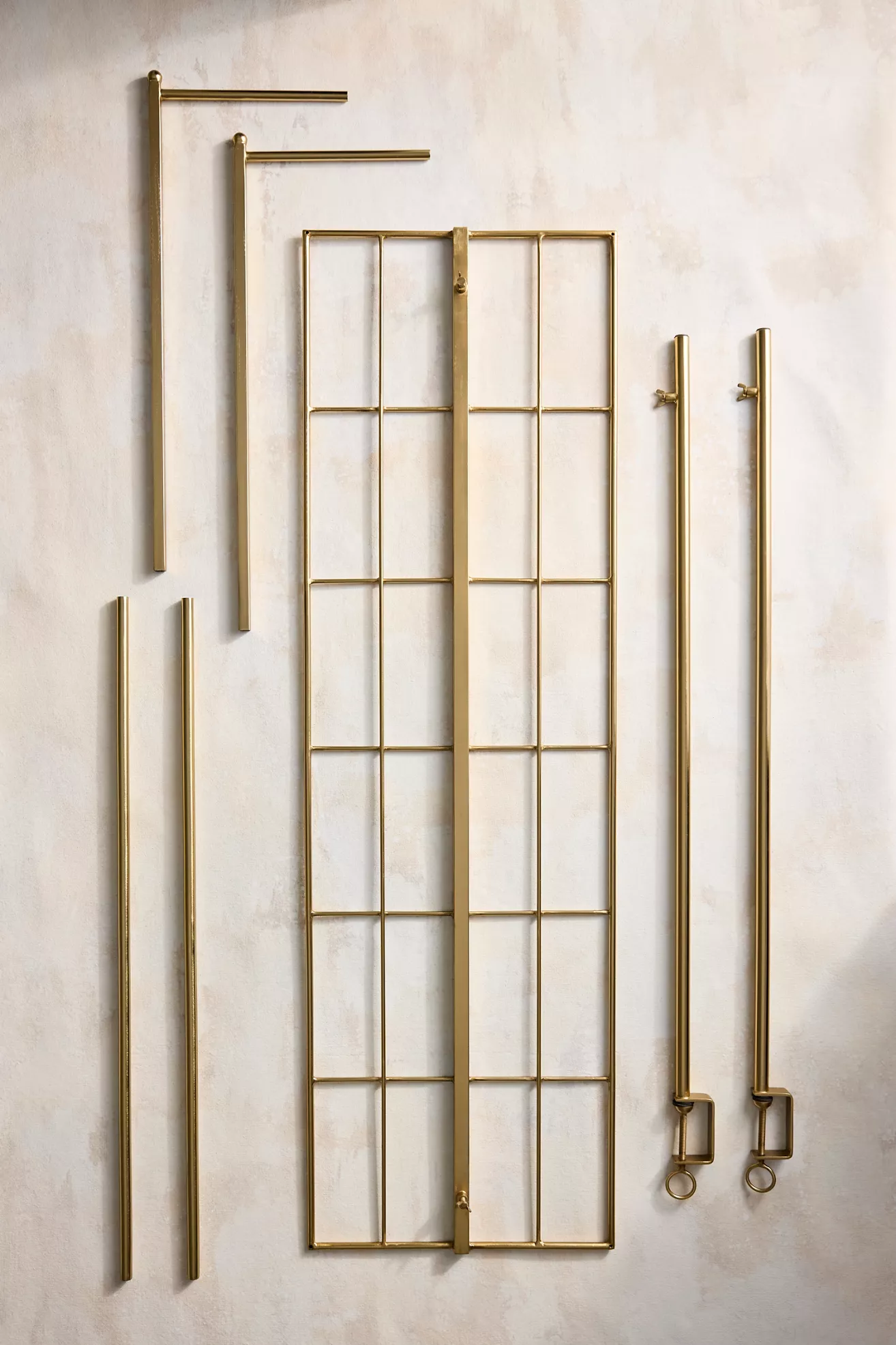 Disassembled gold over-the-table trellis components laid out