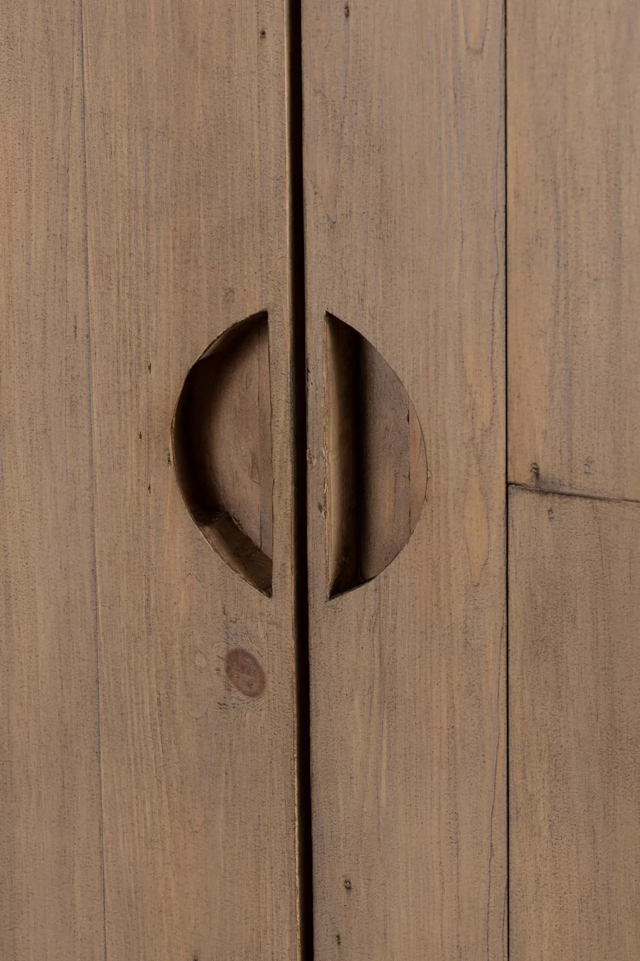 Close-up of circular door handles carved from wood