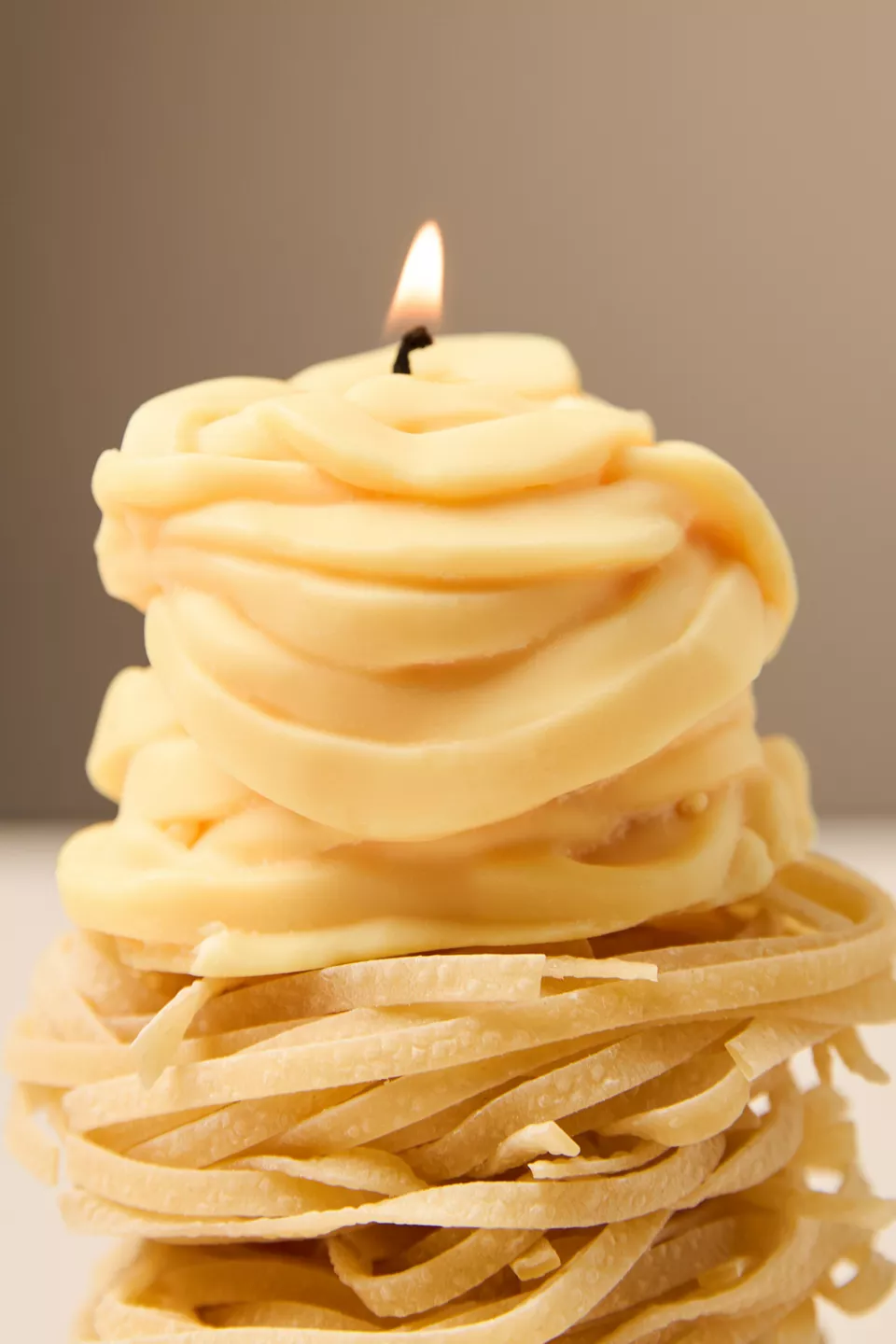 A candle shaped like a pile of spaghetti