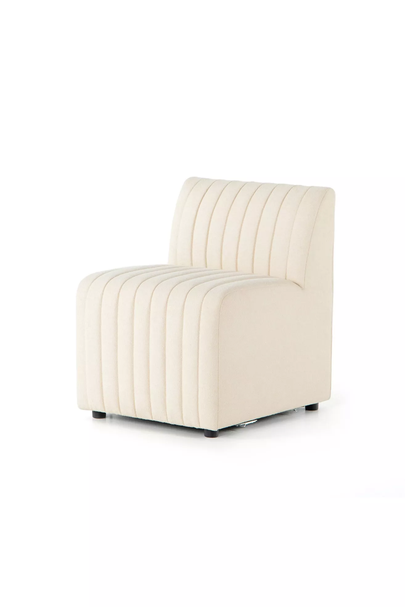 angled view of cream-colored armless chair showing side profile