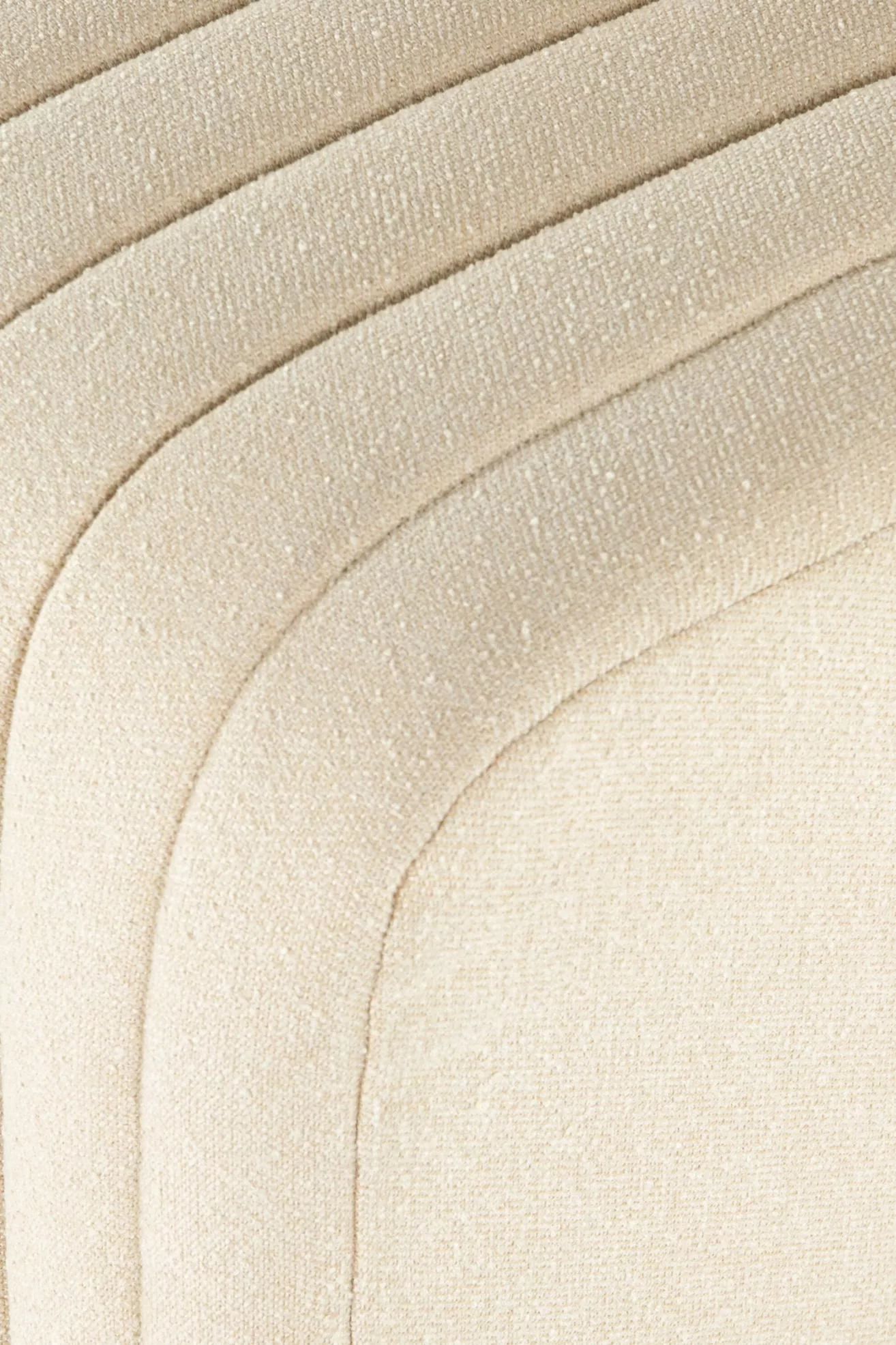 Close-up of cream upholstered vertical channel stitching