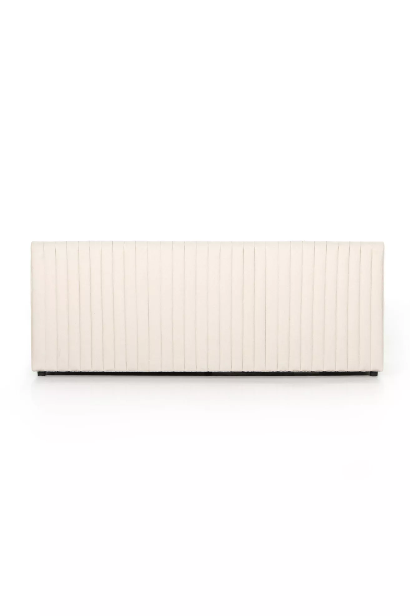 Front view of white tufted dining bench with vertical channels