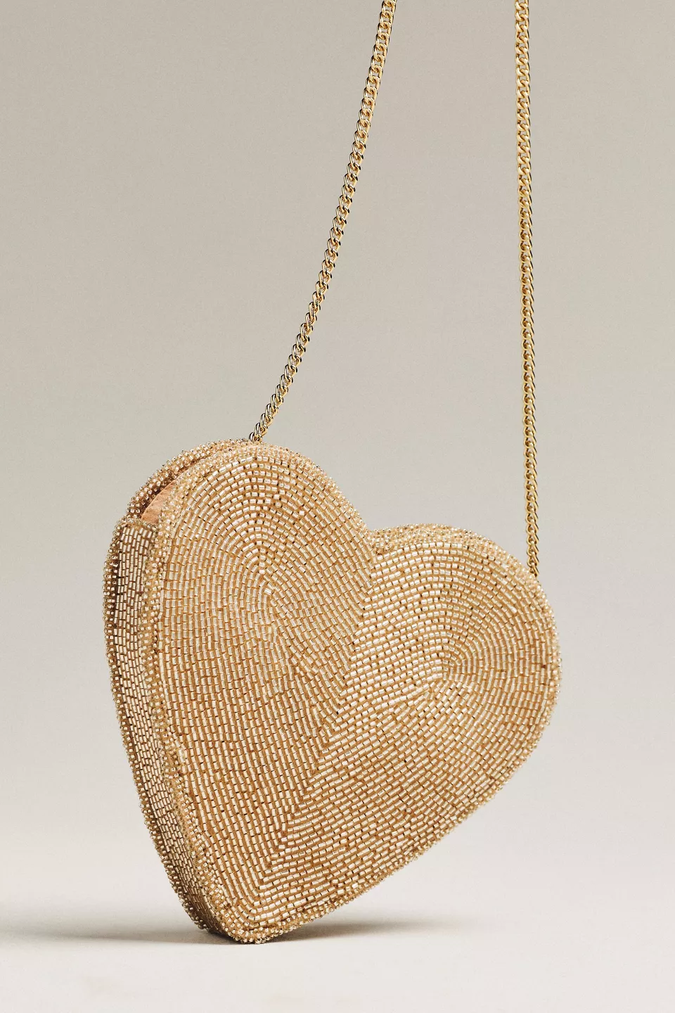 A gold beaded heart shaped purse