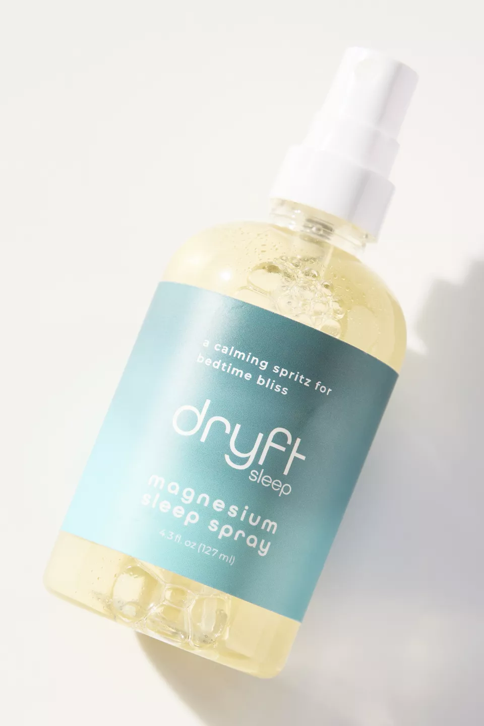 A bottle of spray with a blue label