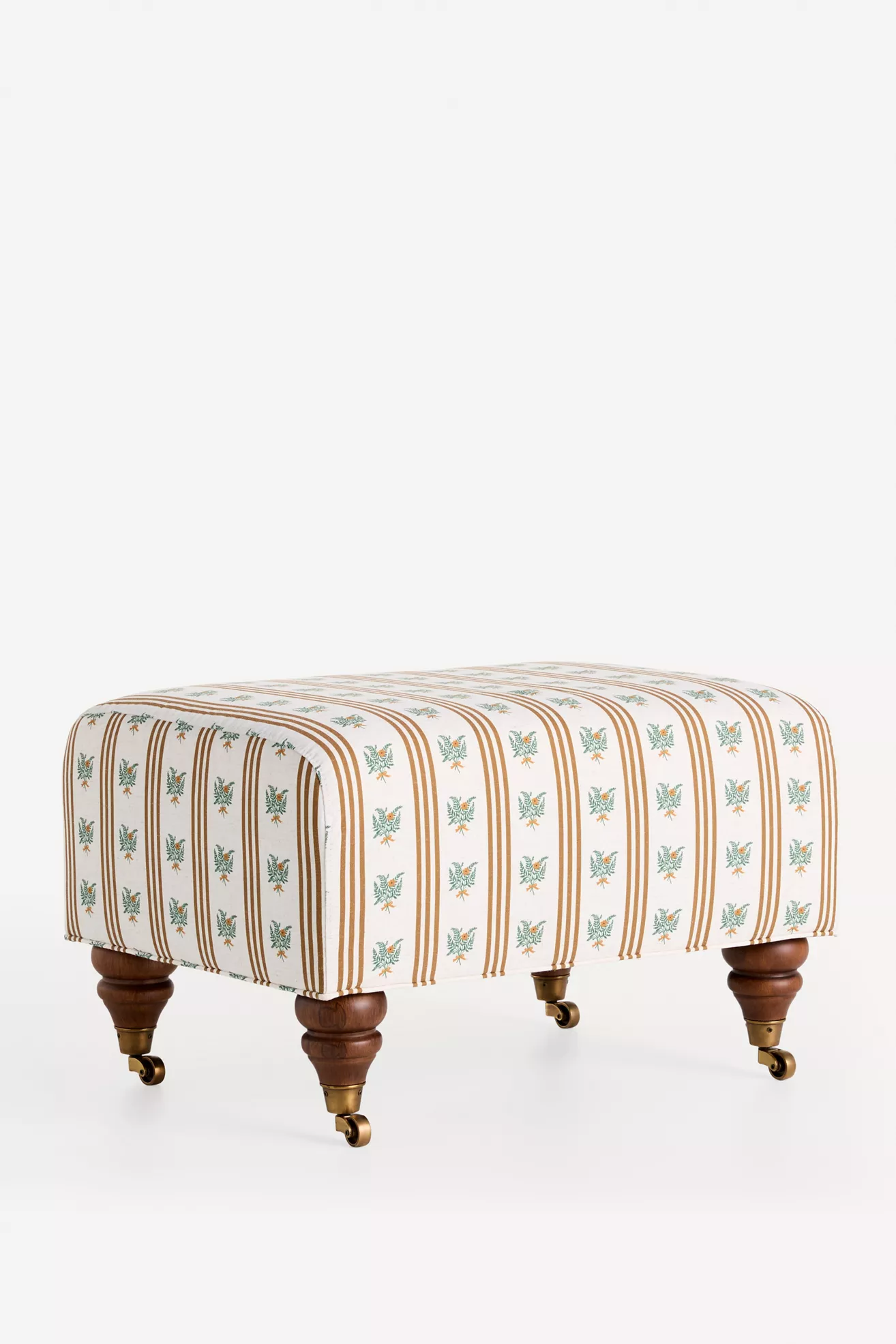 Isolated ottoman with striped floral fabric and wooden legs