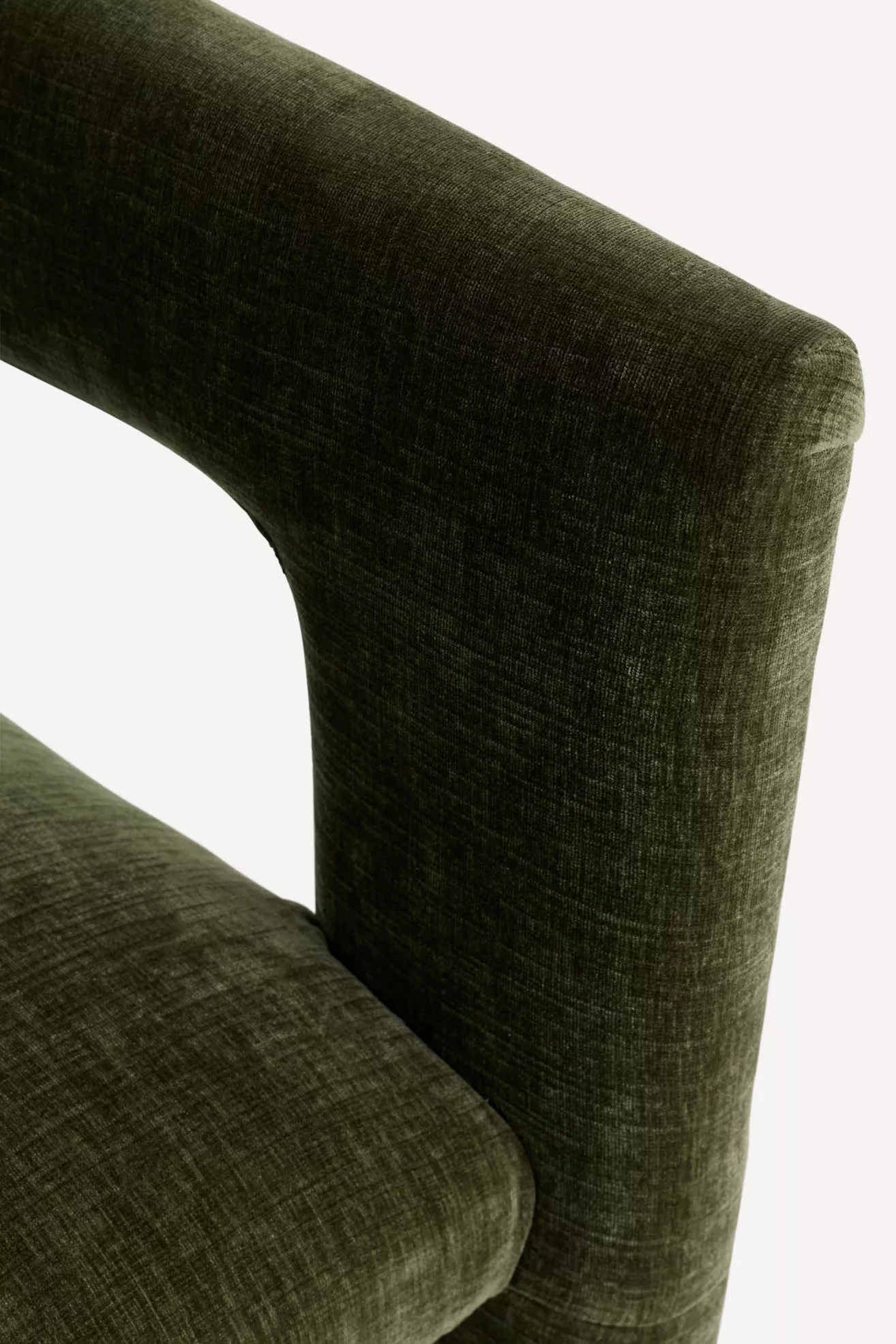 Close-up of dark green velvet fabric texture on chair