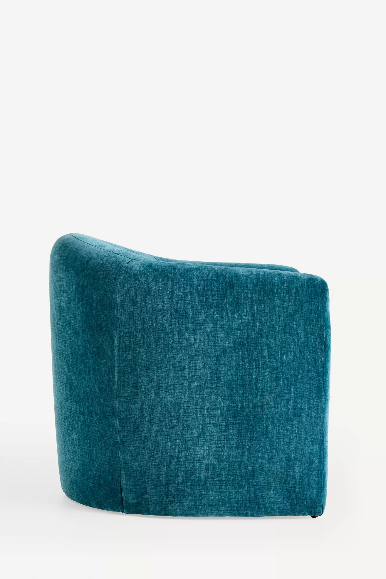 Teal velvet armchair seen from the side