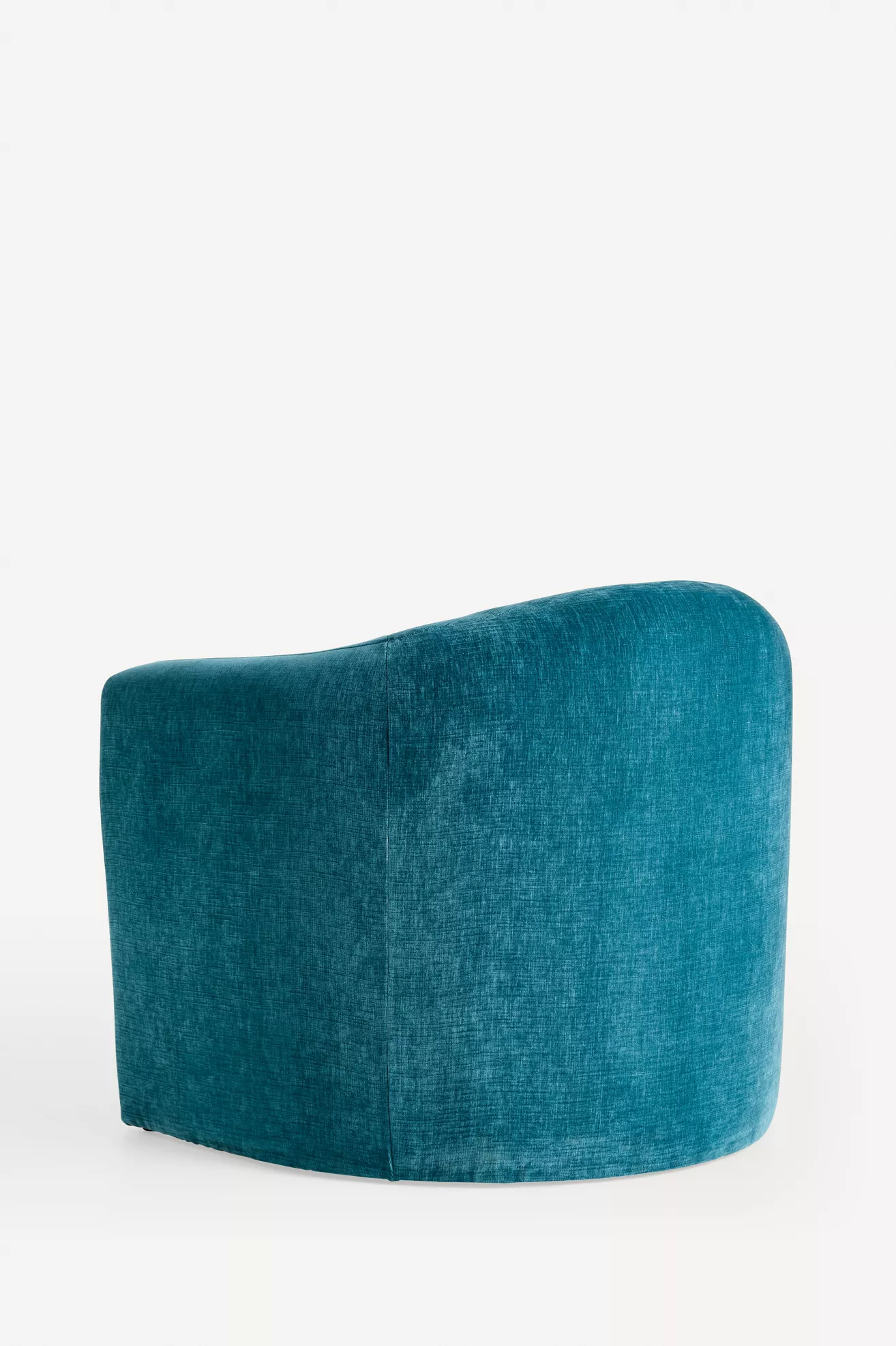 Teal velvet armchair seen from a three-quarter angle