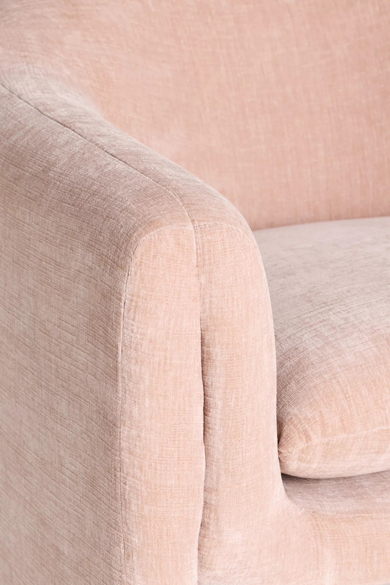 Close-up of pink velvet chair fabric and seam