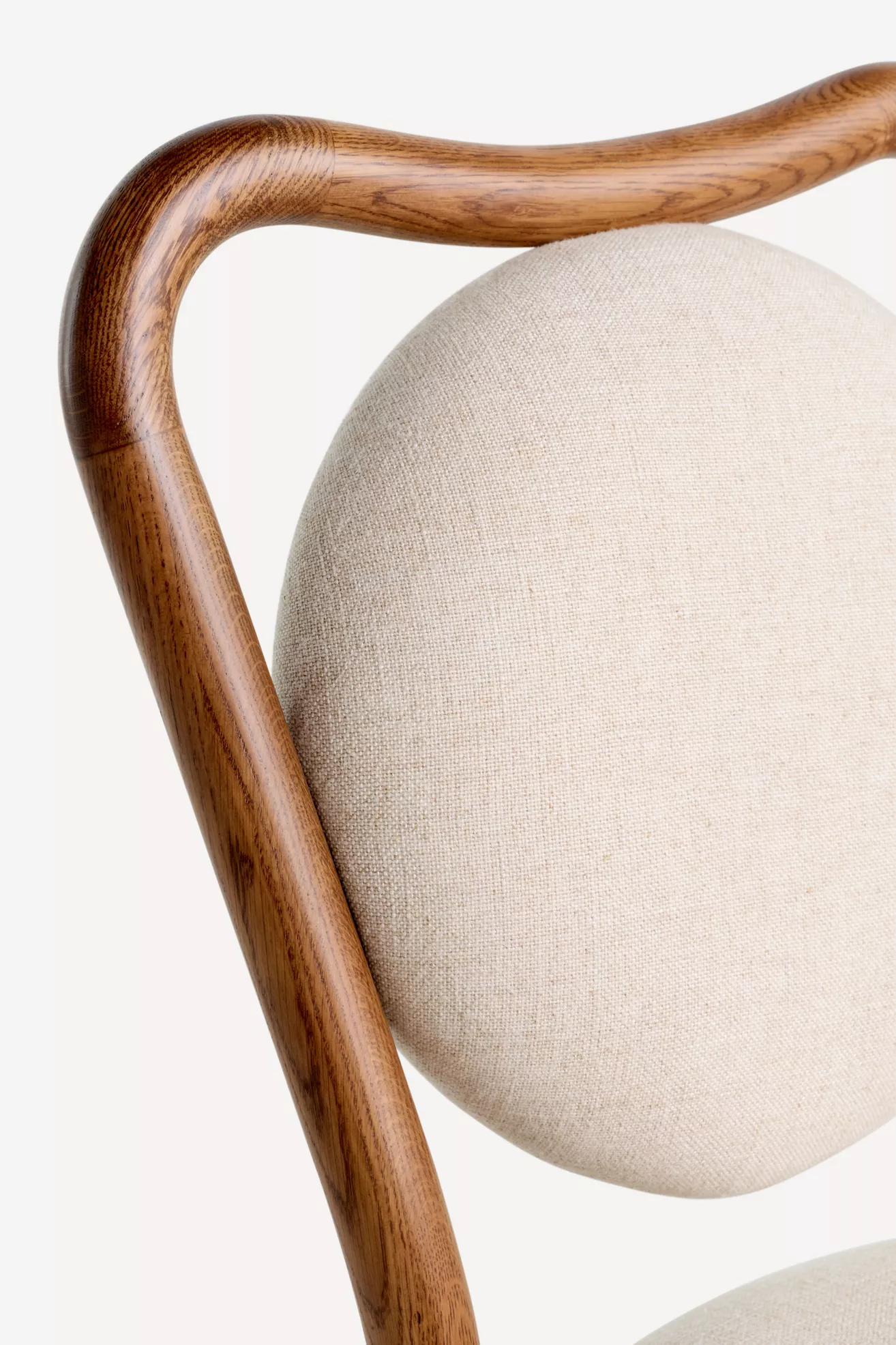 Close-up of wooden back rail and upholstery