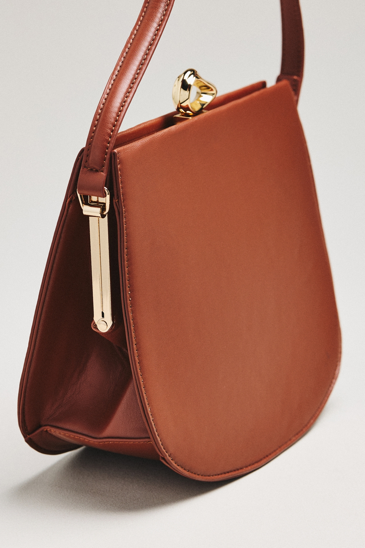 By Anthropologie Kiss-Lock Smooth Satchel
