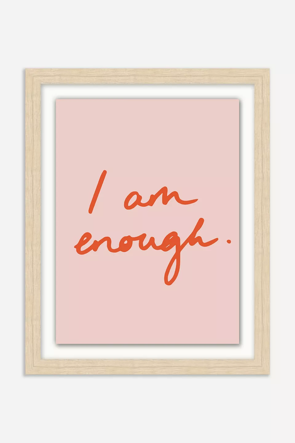 Pink artwork with red text inside a wooden frame