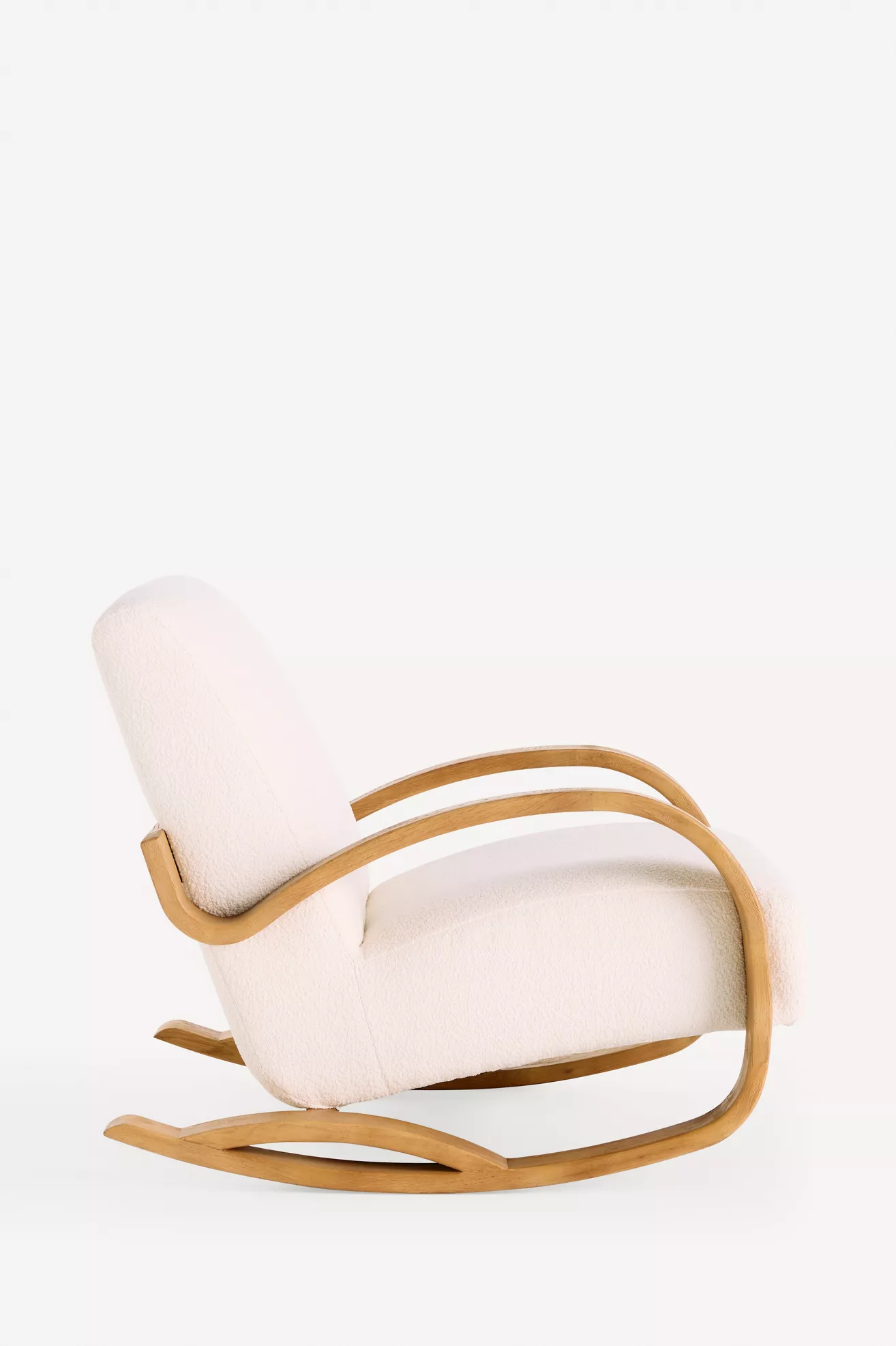 Side view of white upholstered rocking chair with curved wooden arms
