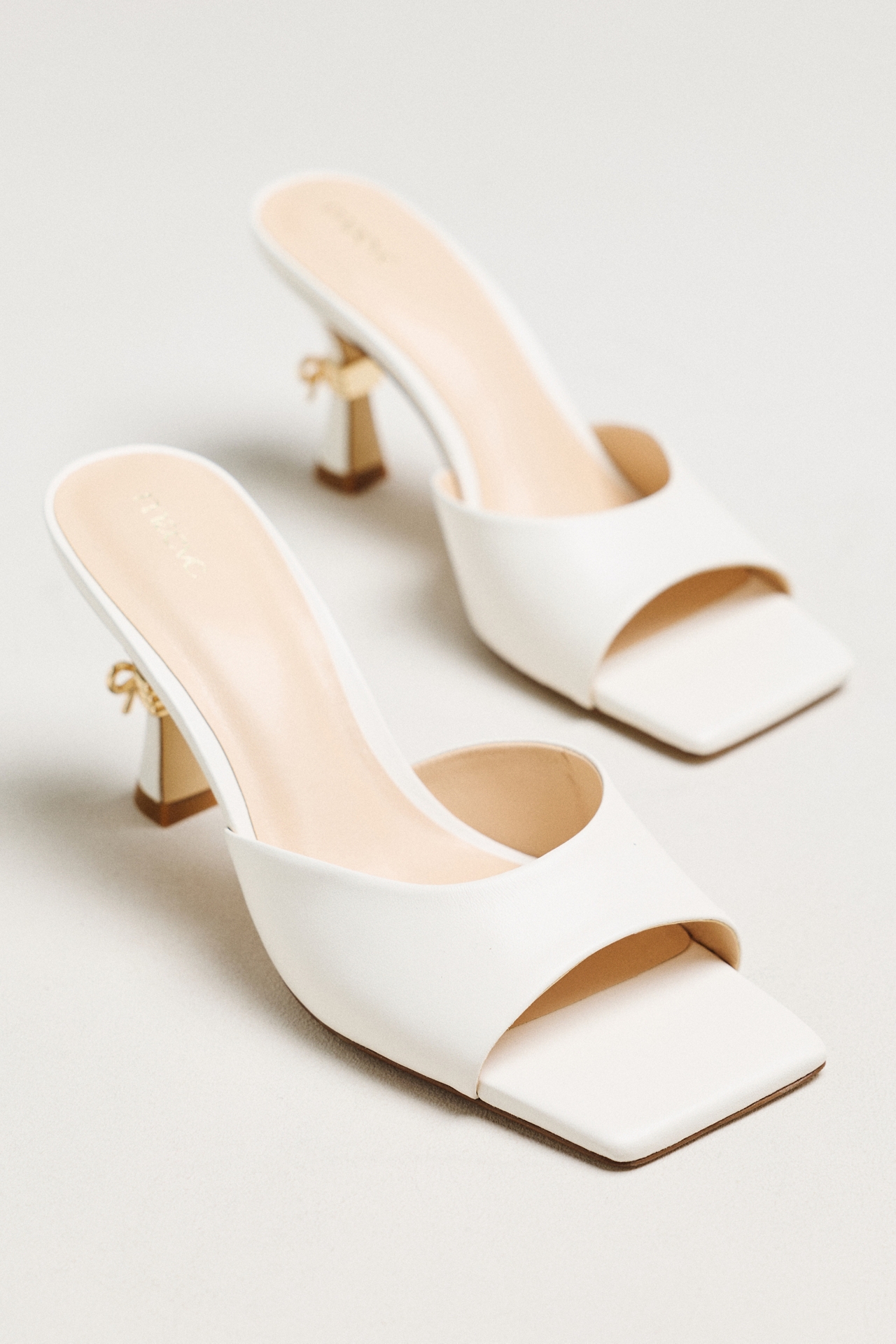 Maeve Metal Bow Open-Toe Mule Heels