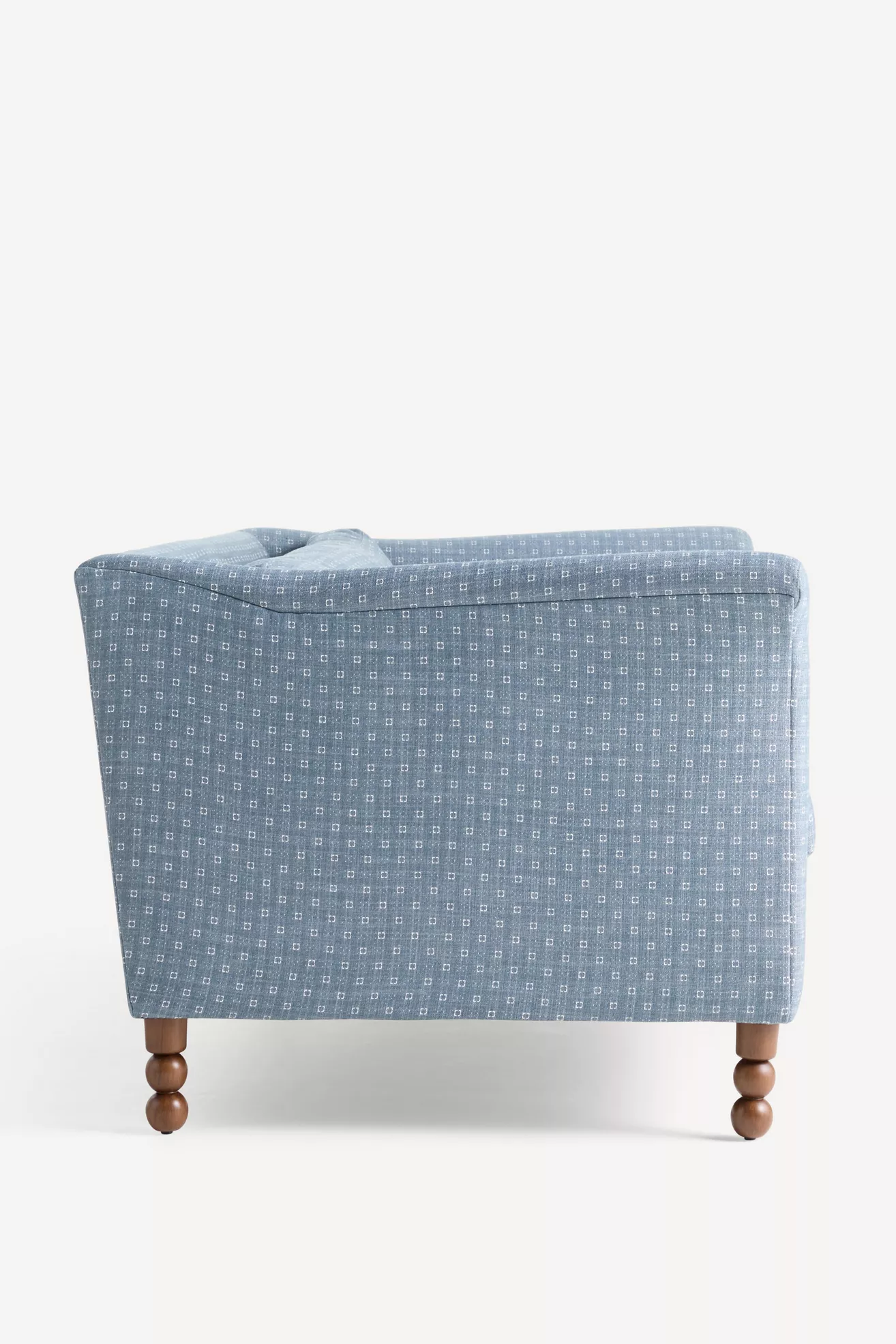 Selma Golini 79 sofa back view in blue patterned fabric and turned wooden legs
