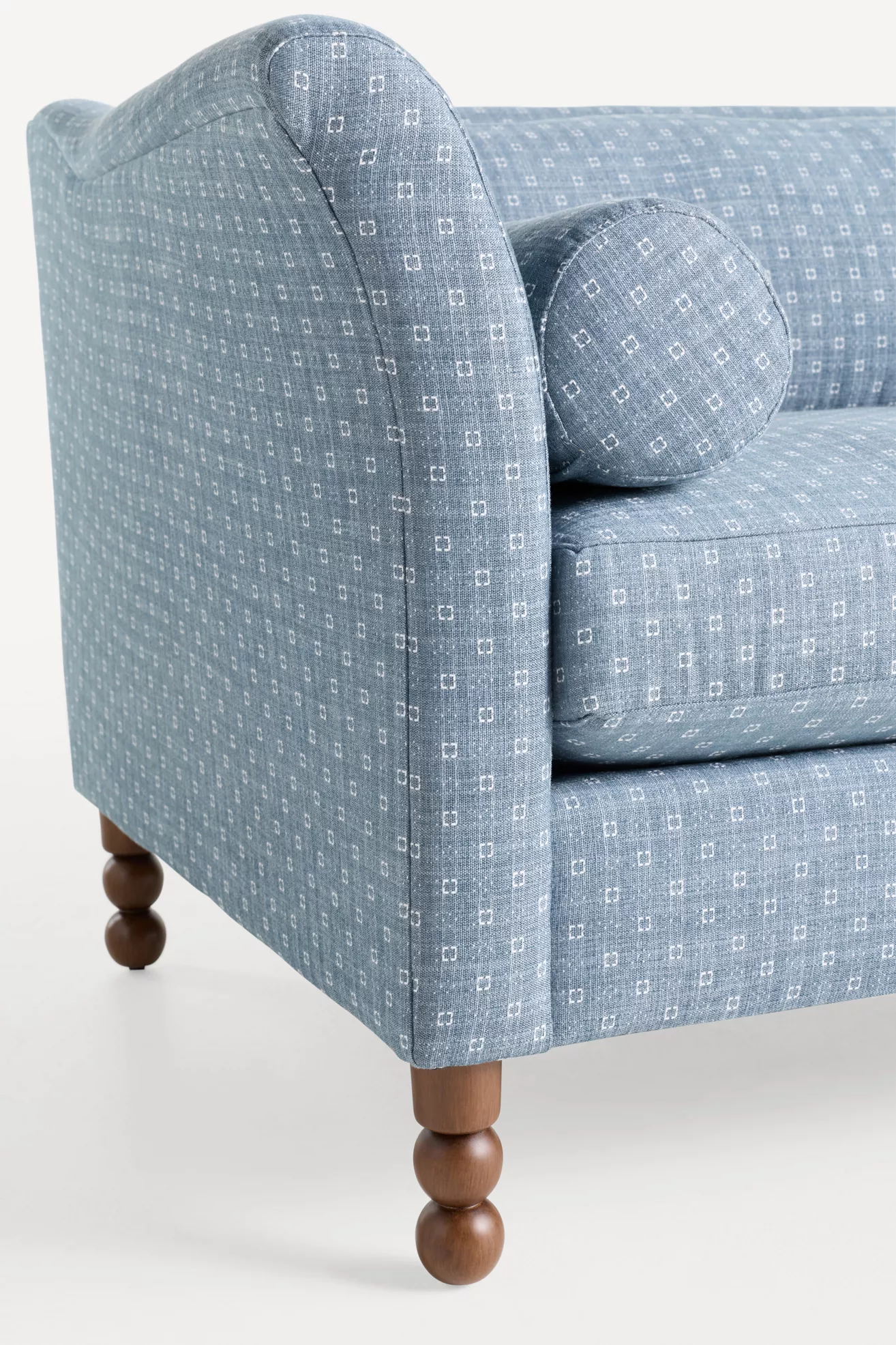 Close-up of Selma Golini 79 sofa rolled arm and turned wooden leg