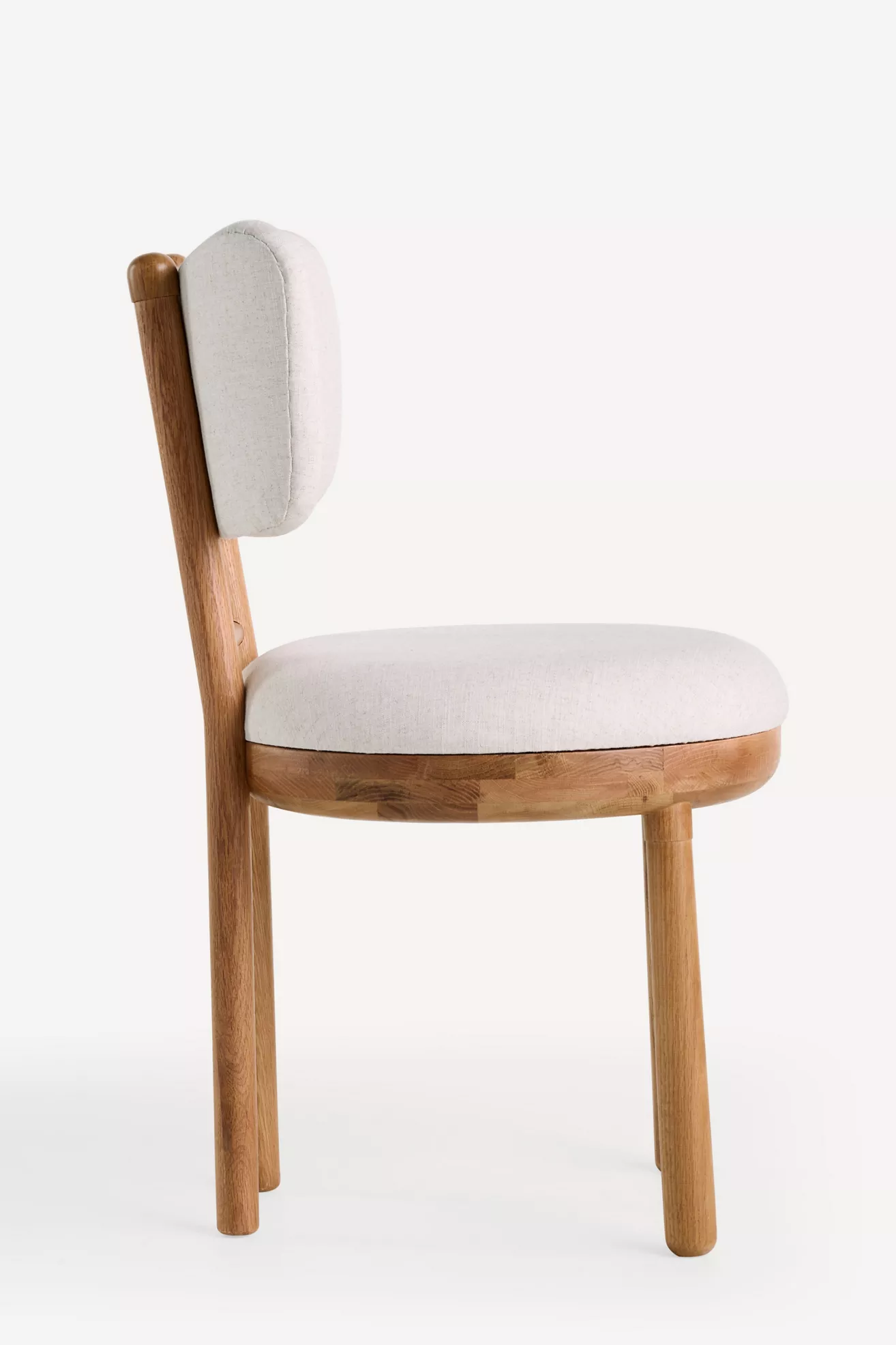 Side angle view of Irie Linen Dining Chair with wooden legs and rounded seat