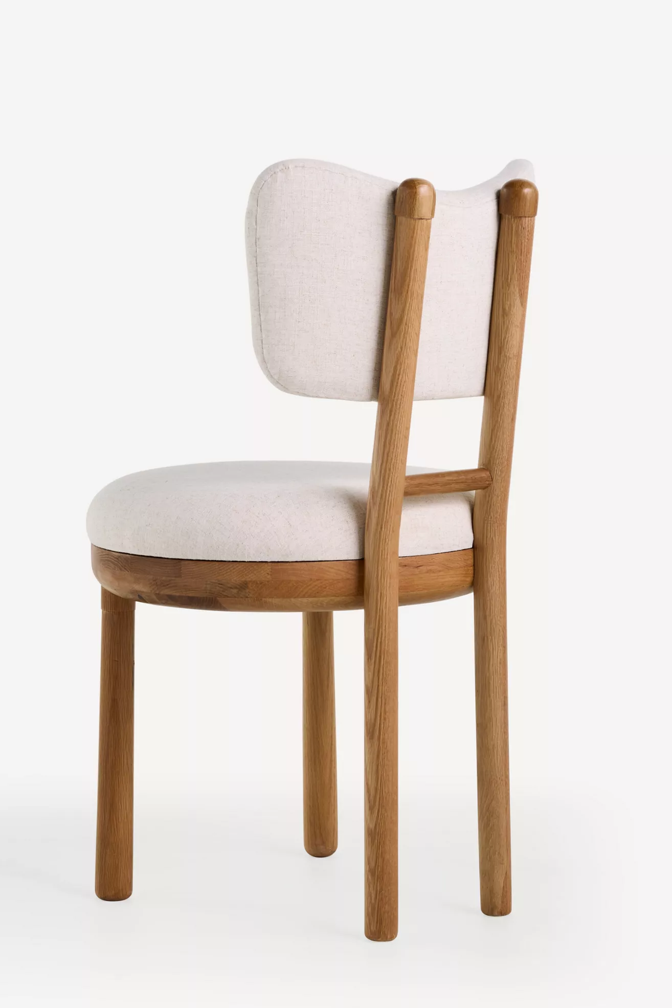 Rear three-quarter view of Irie Linen Dining Chair showing backrest and legs