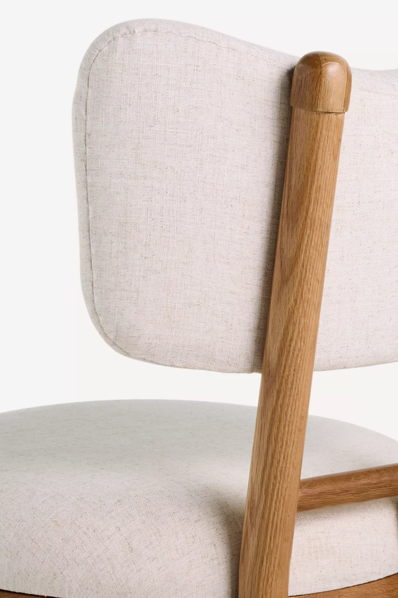 Close-up of the chair’s upholstered back and wooden post