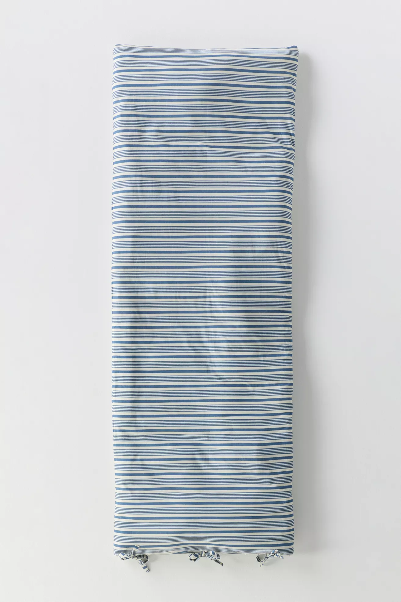 Blue and white striped fabric with tassels at ends