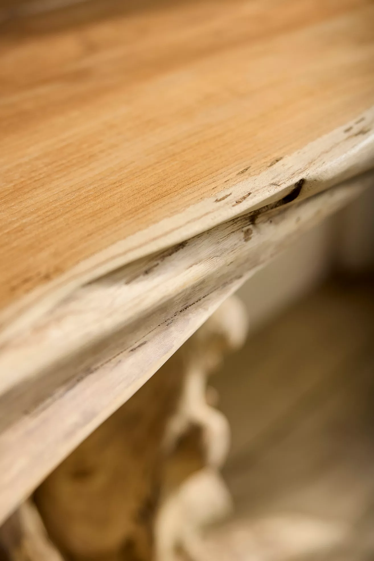 Close-up of the console top edge showing wood grain and distressed finish