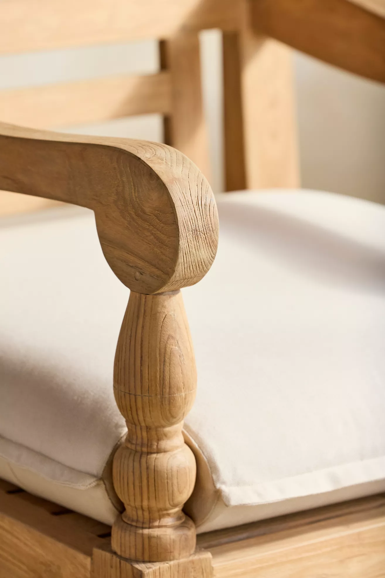 Close-up of curved arm and cushion edge