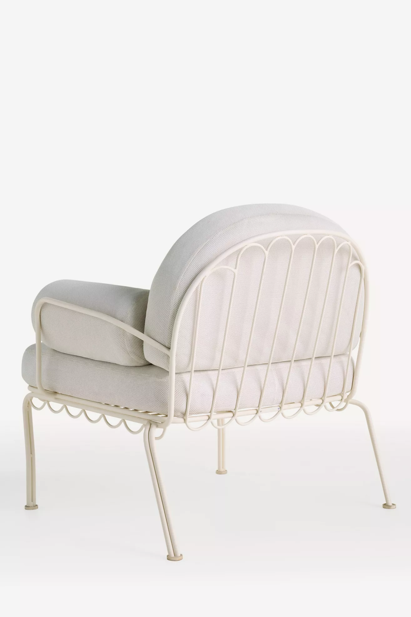 Rear angle of the chair showing frame piping and scalloped trim