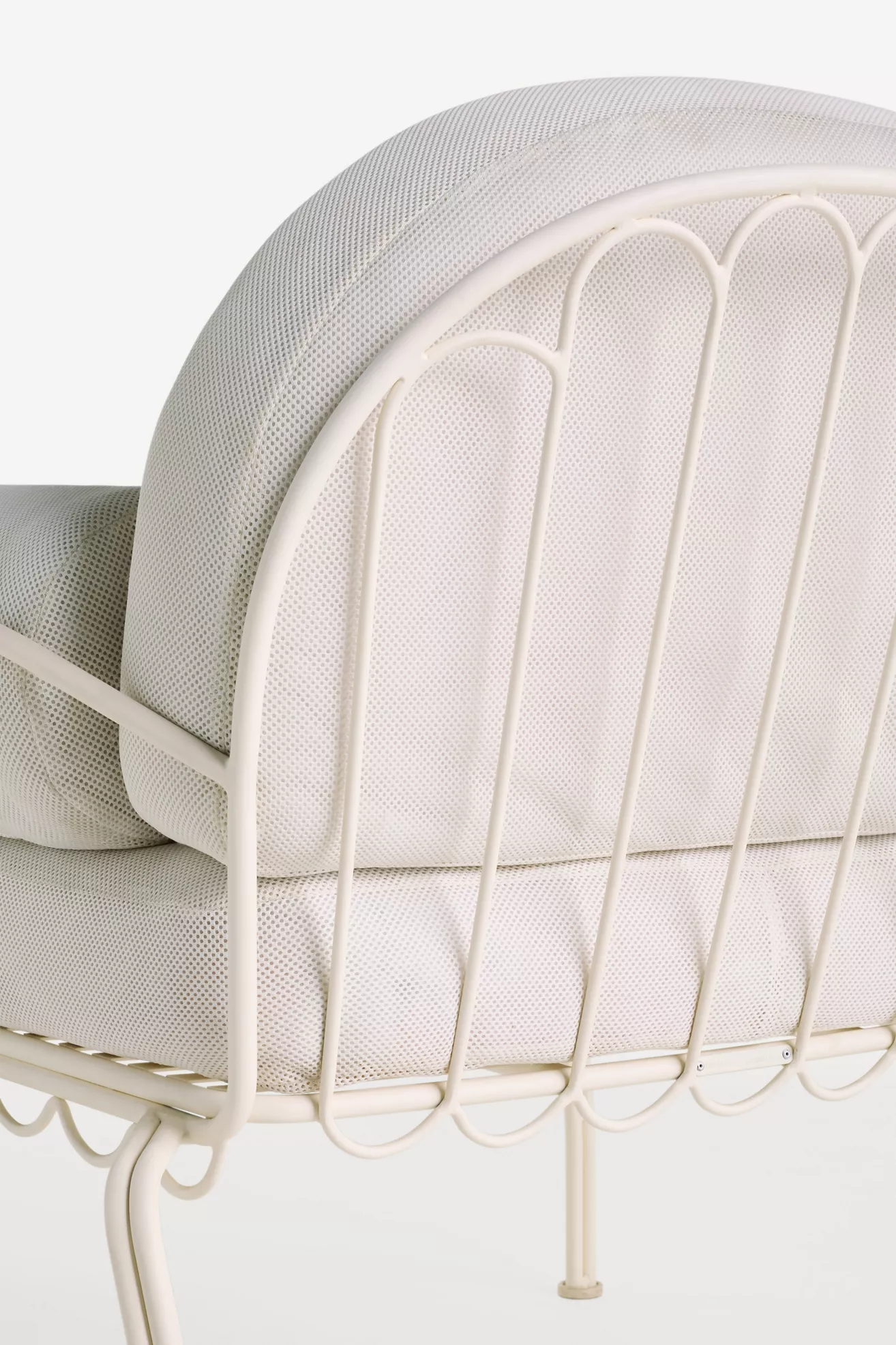 Close-up of the chair back showing metal frame and mesh cushion