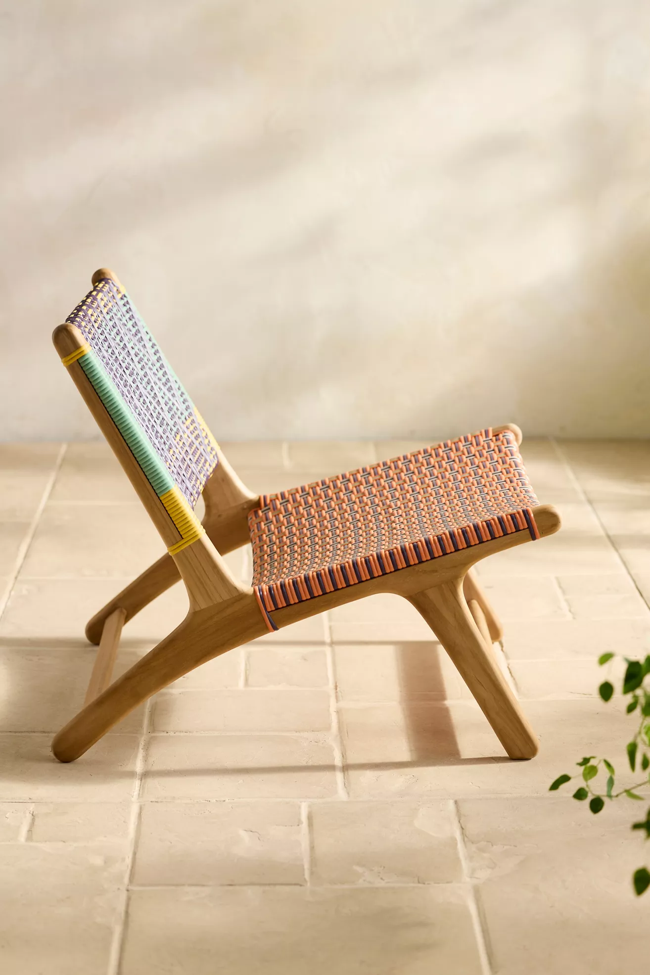 Side-angle view of Havana wicker armless chair in colorful weave