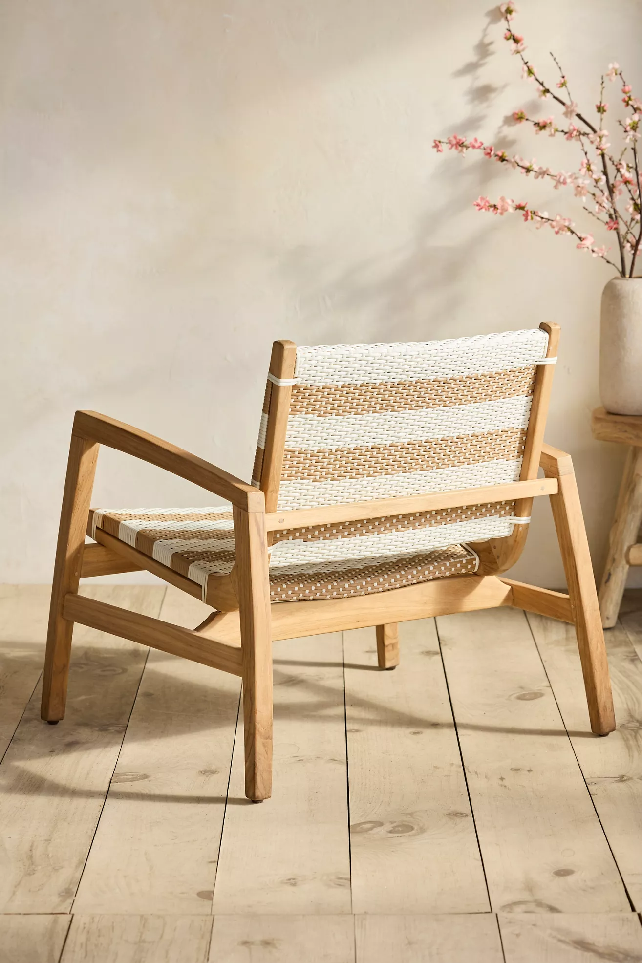 Back-angled view of woven lounge chair showing side profile