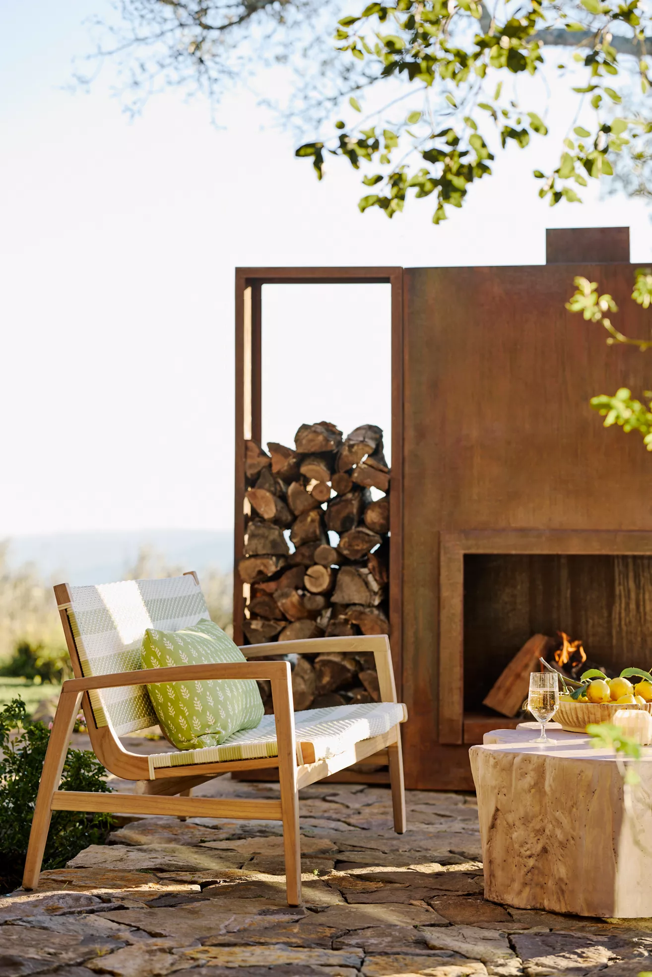 Outdoor fireplace with wooden chair