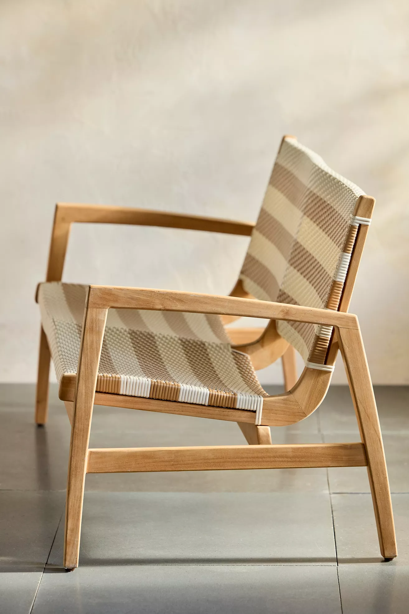 Side angle view of wicker chair with wooden frame
