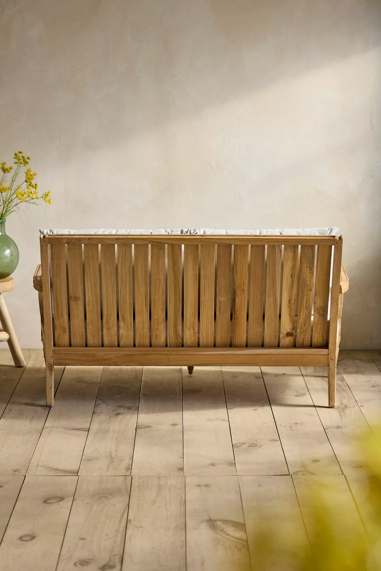 Back view of teak two-seat sofa showing slatted back