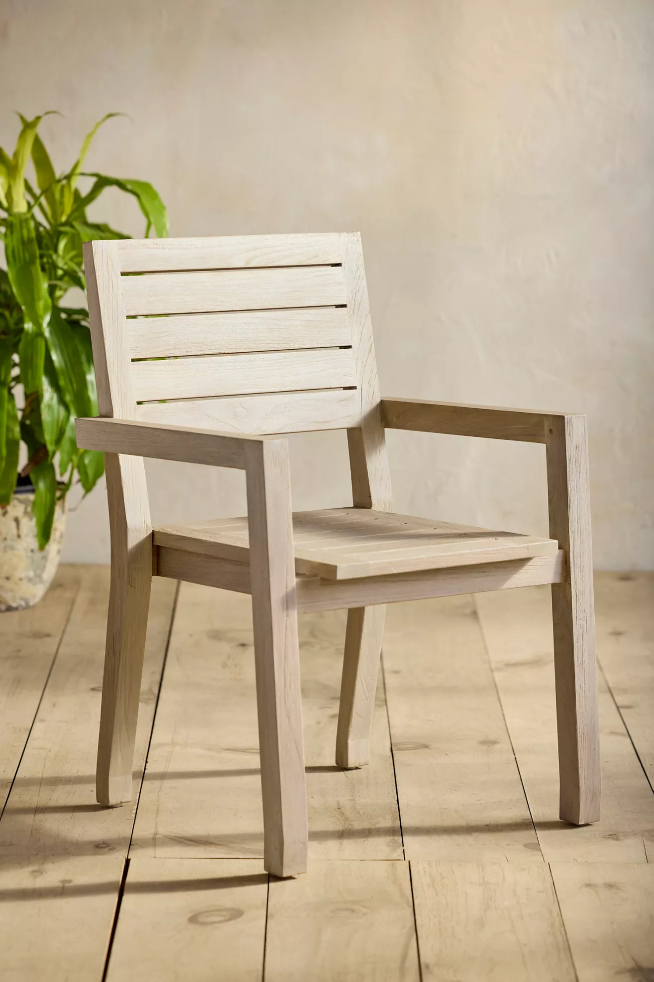 Front-left angled view of single slatted teak chair
