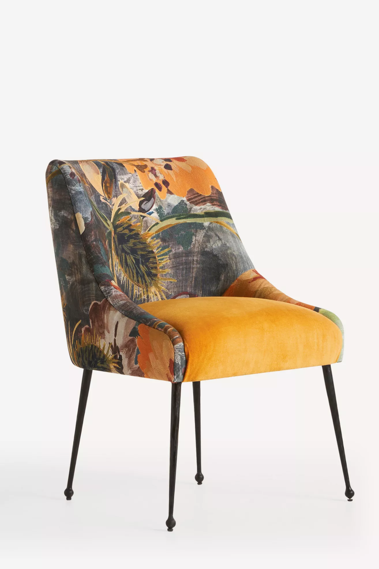 Velvet chair with yellow seat and printed back in a living room style setting