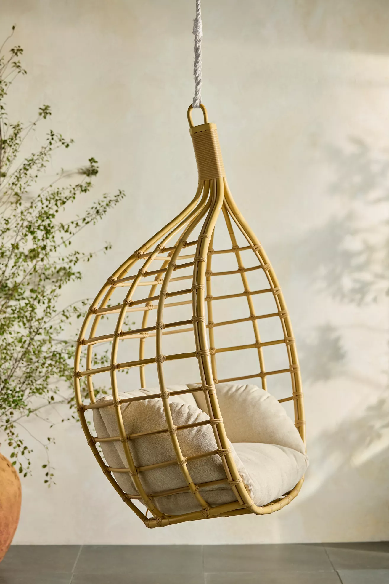 Side view of hanging chair showing lattice frame and cushion