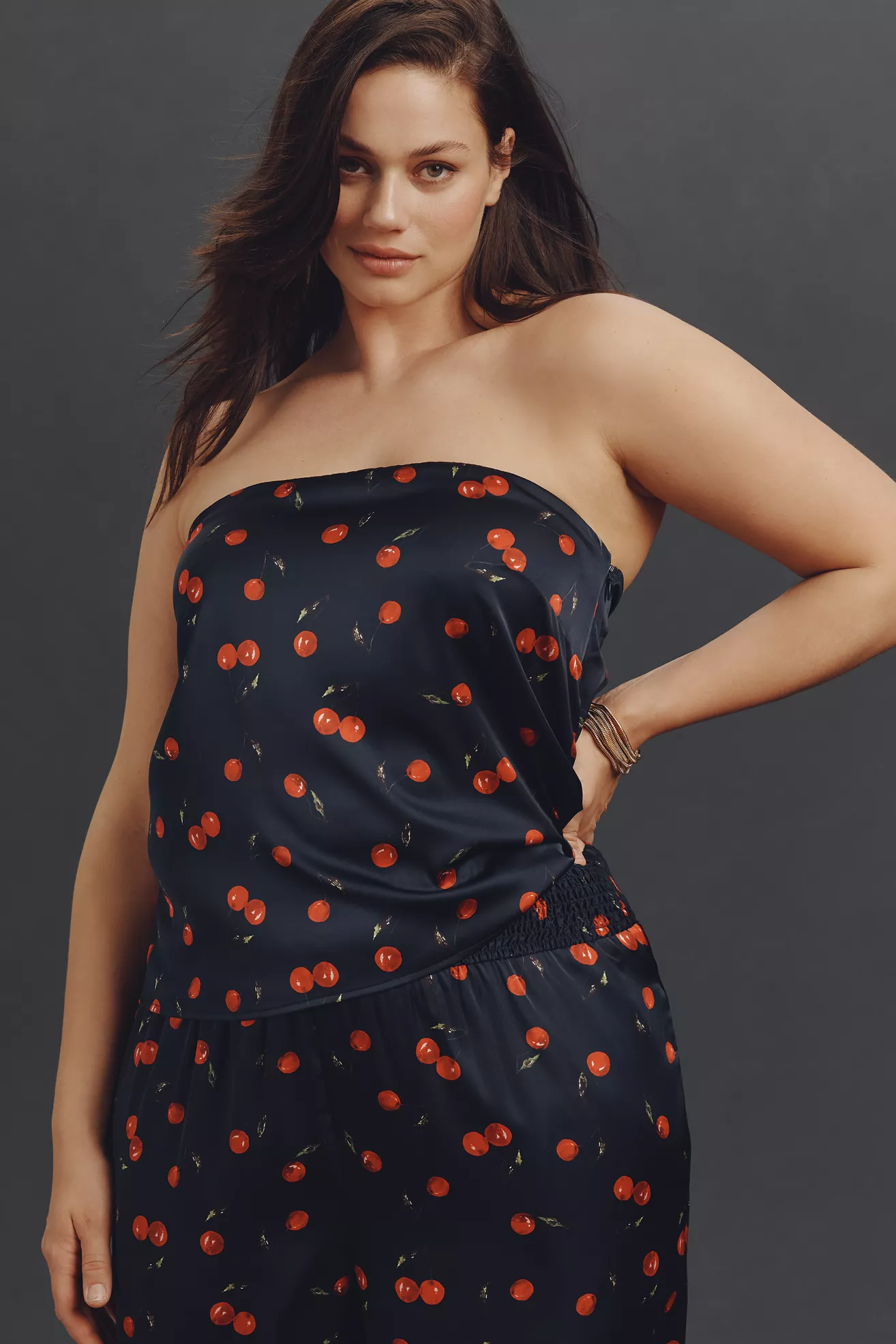 A plus-size, black, cherry print, strapless satin top
