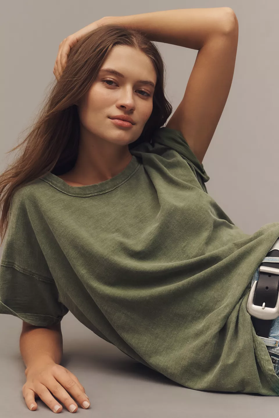 A woman wearing a green oversized tee