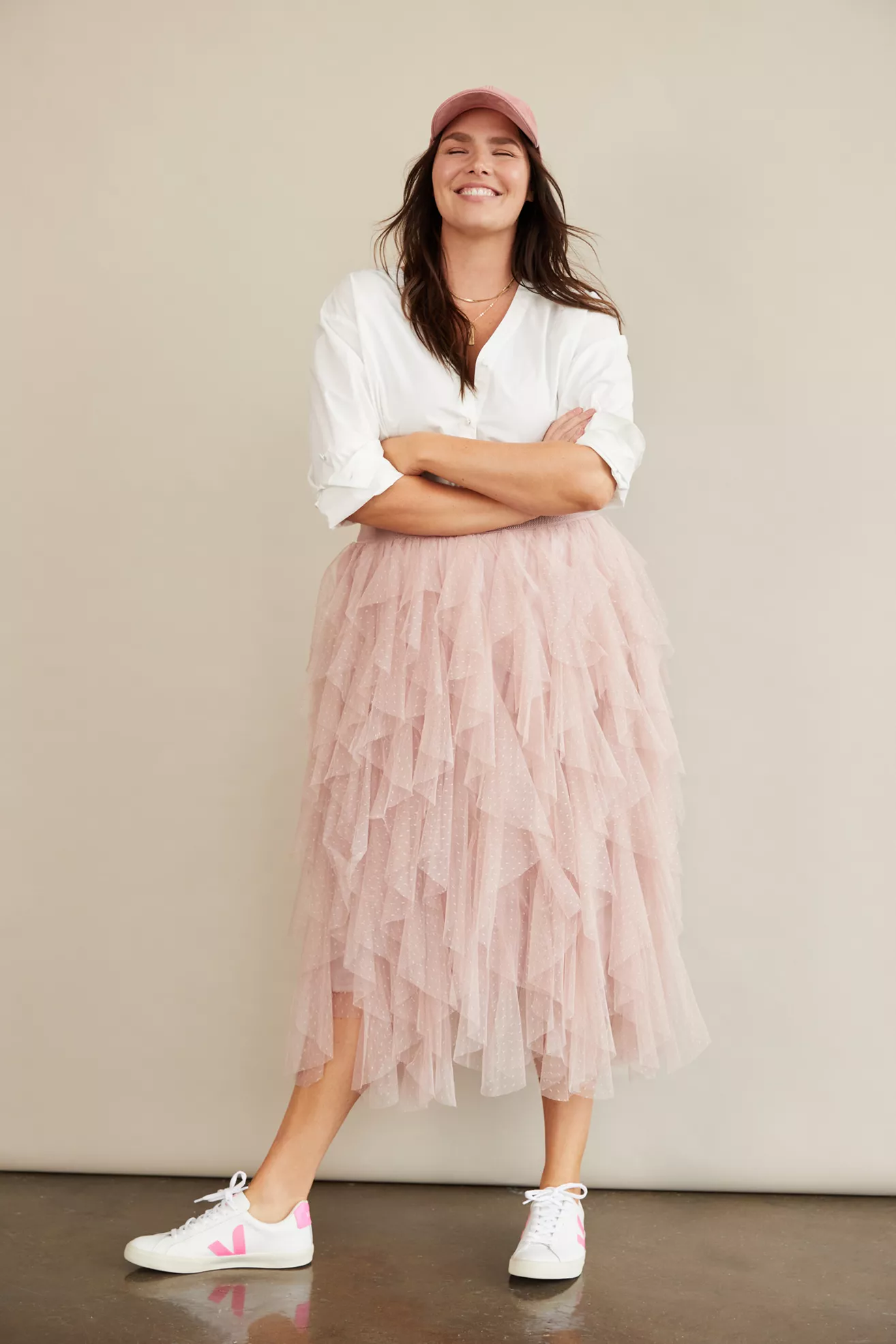 A plus-size, light-pink, ruffled tulle skirt