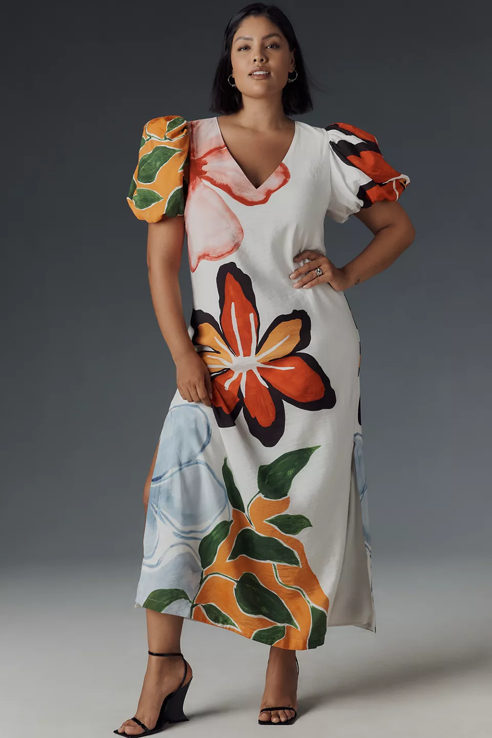 A plus-size, white, puff-sleeve midi dress with large colorful florals