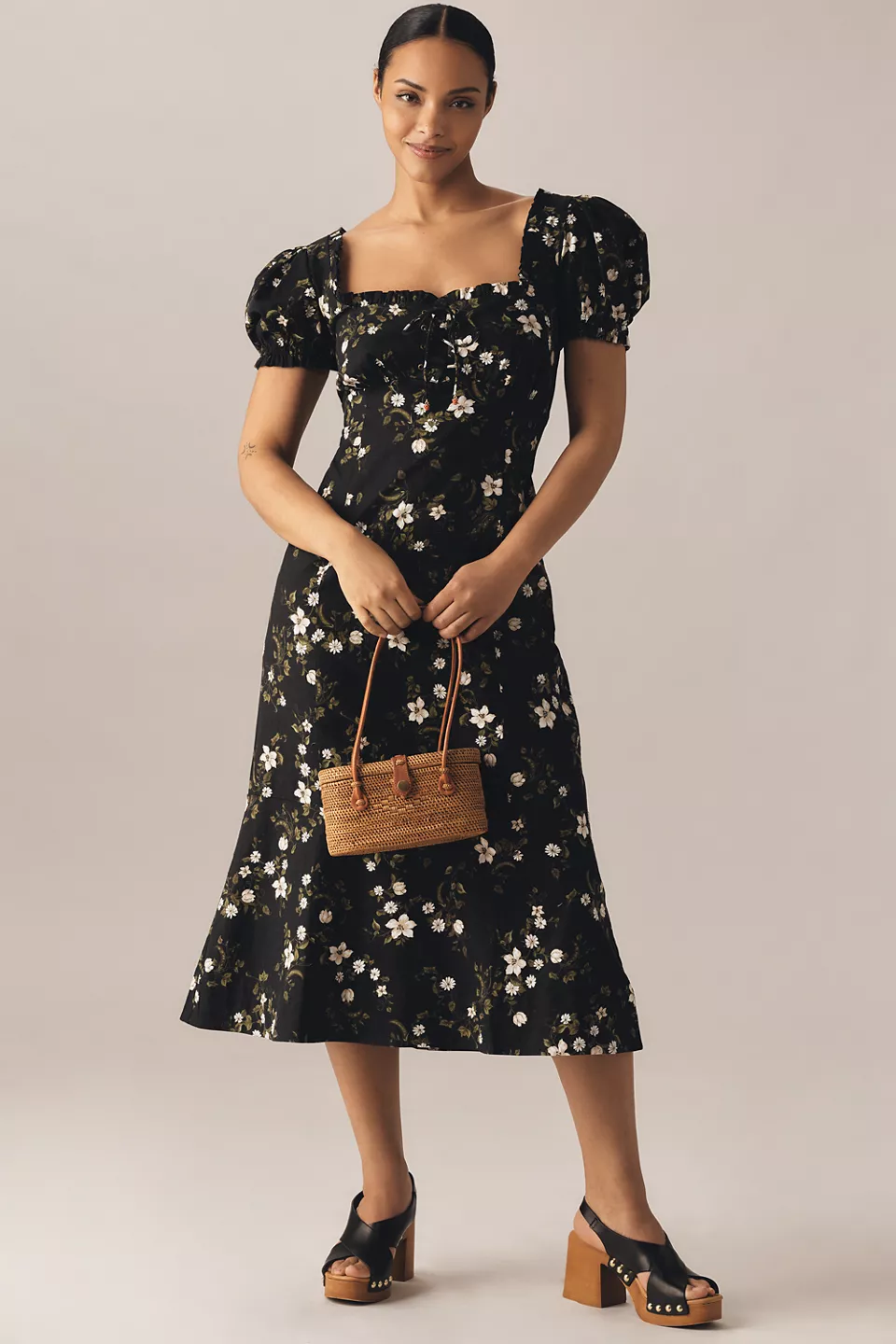 A plus-size, puff-sleeve, black-and-white floral midi dress