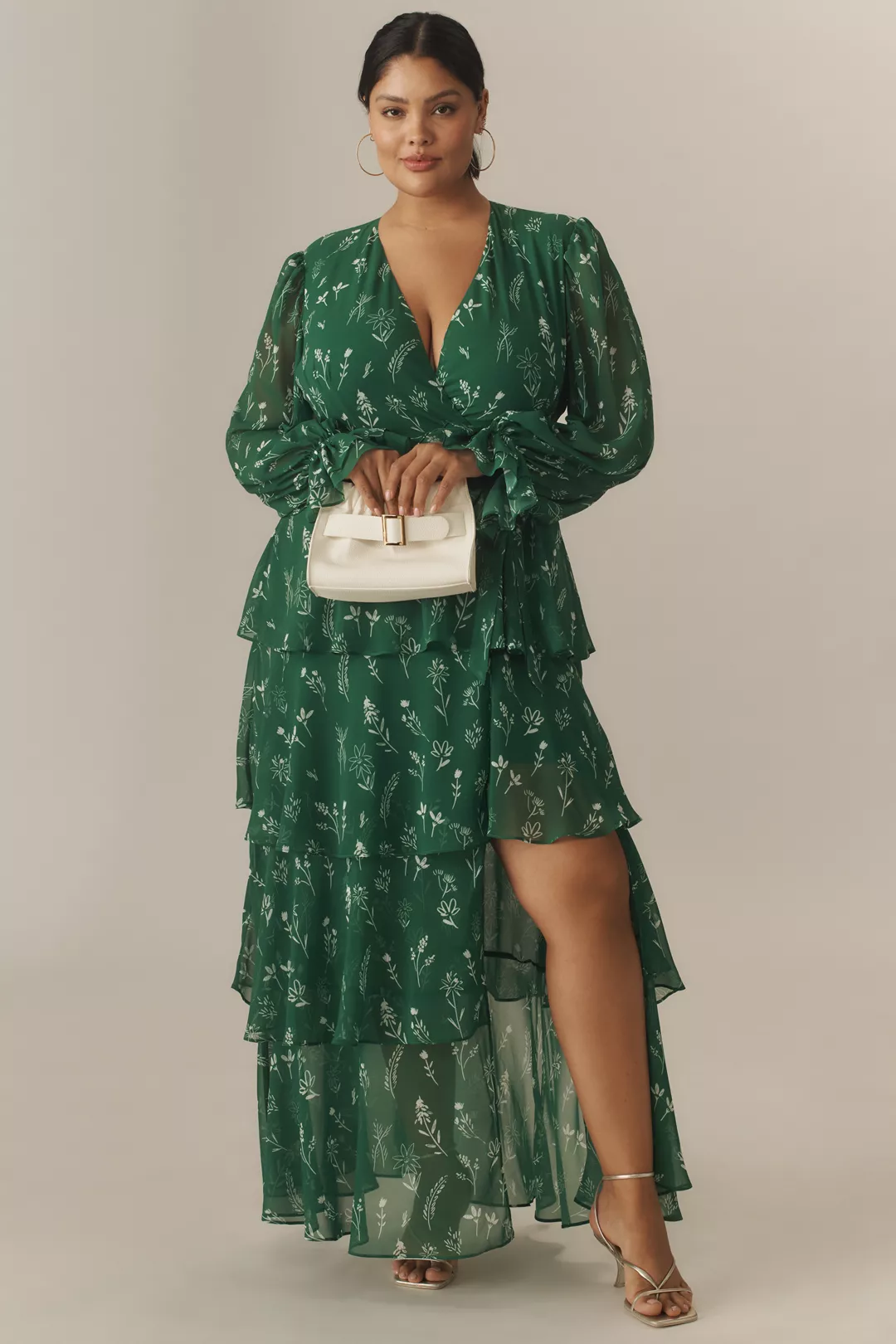 A plus-size, forest-green printed maxi ruffled dress