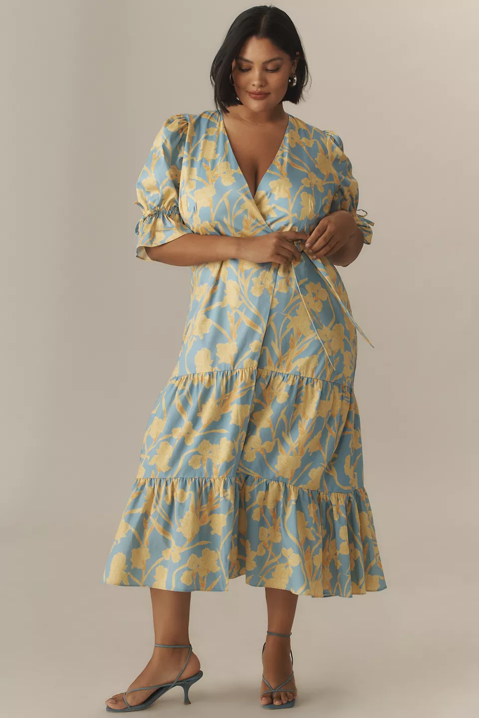 A plus-size, puff-sleeve, blue-and-yellow floral wrap dress