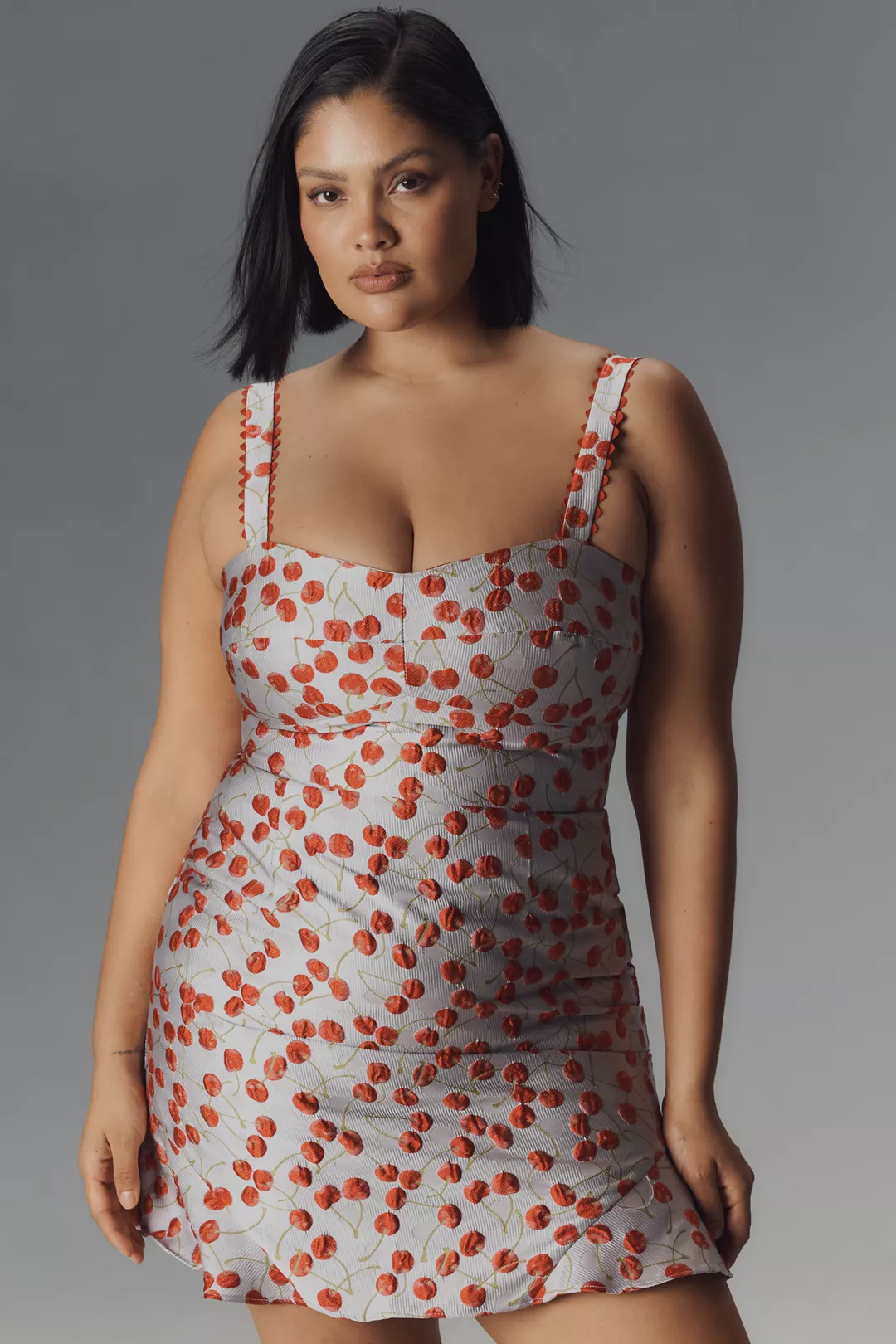 A plus-size gray, cherry-print mini dress