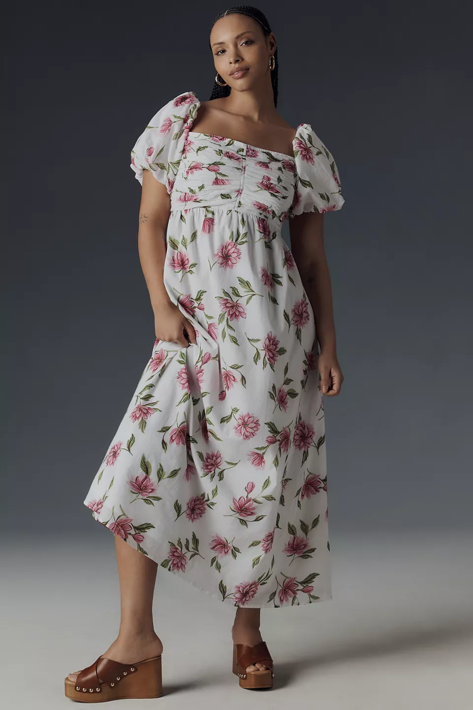 A plus-size, puff-sleeve, white babydoll dress with a pink-and-green floral print