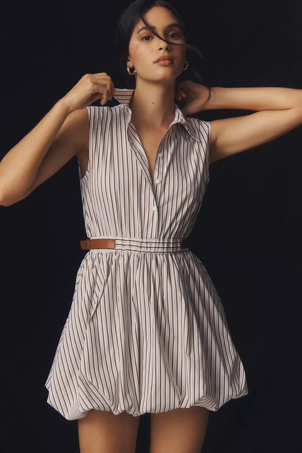 A pinstripe bubble dress with a belted waist, a collar, and a button-up neckline